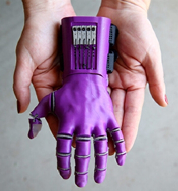 Photo of a person's hands holding a prosthetic hand