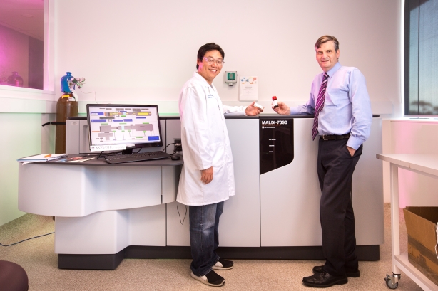 Image of two men in a laboratory looking at medicine