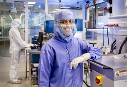 Female scientist wearing PPE inside a lab