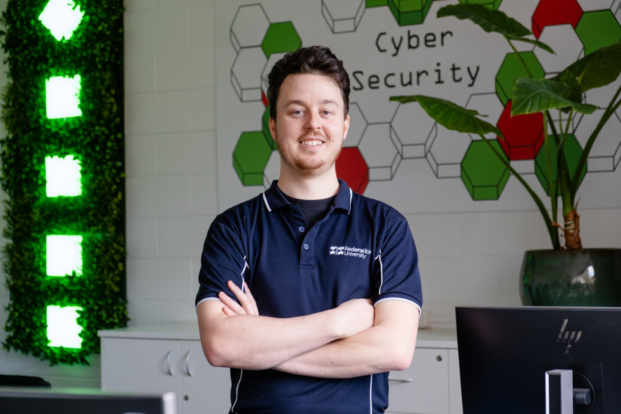 Dr Adam Bignold standing with arms crossed in front of a