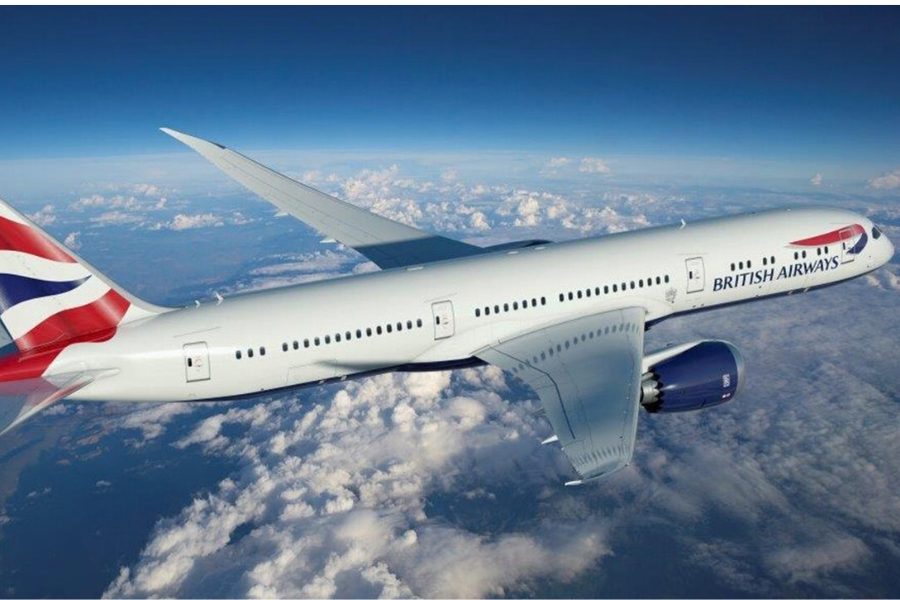 A British Airways plane in flight at a high altitude with cloud in background.