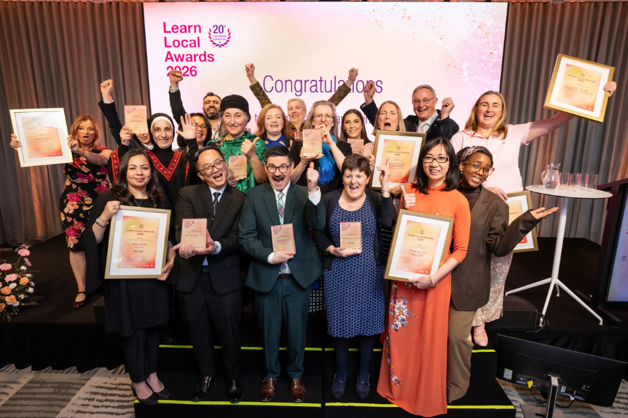 The group of winners holding certificates and awards joyously from the Learn Local Awards 2026