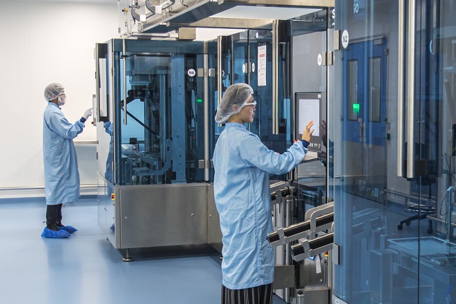 Photo of two laboratory workers in a lab