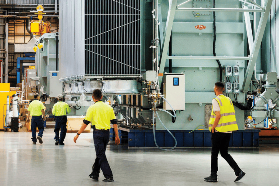 Workers in high-vis in an industrial workspace.