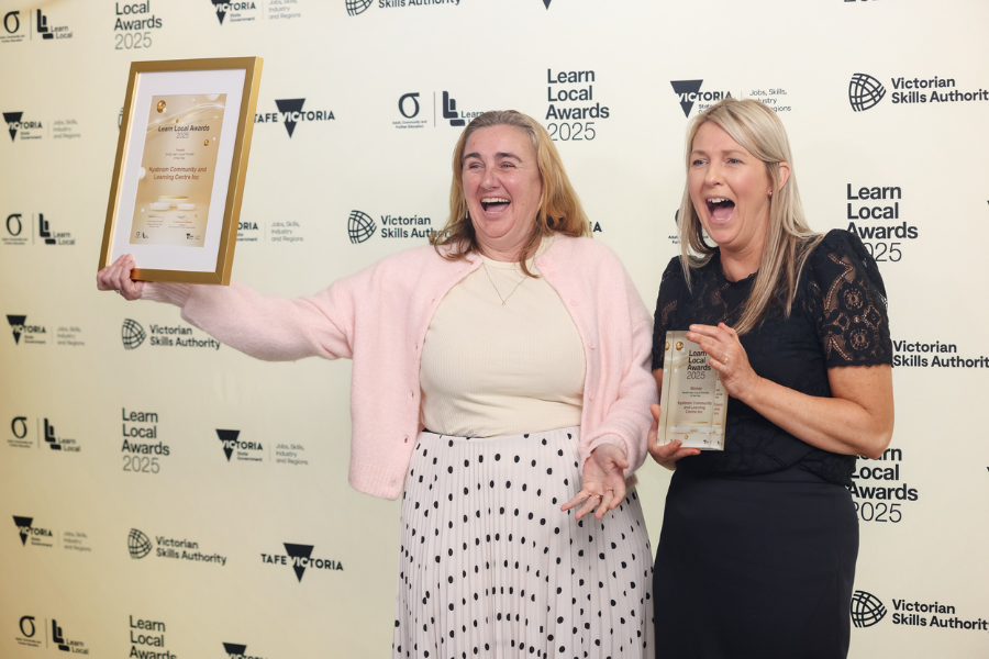 Two individuals accepting the 2025 Small Provider of the Year Award 
