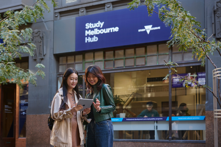 Two international students standing outside the Study Melbourne Hub.