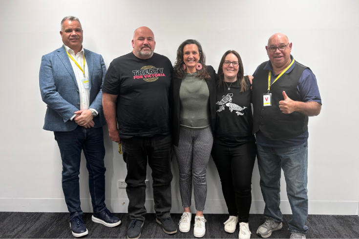 Representatives from 4 First Peoples Victorian businesses stand in front of wall smiling at camera.