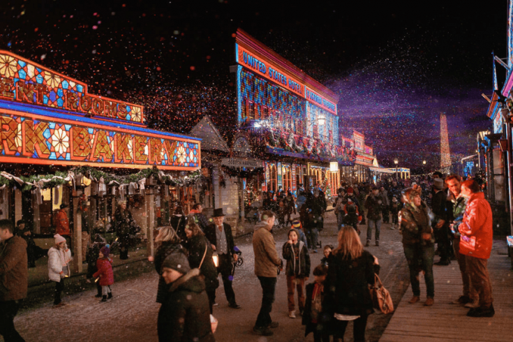 Visitors on the street enjoy Sovereign Hill’s Winter Wonderlights festival.