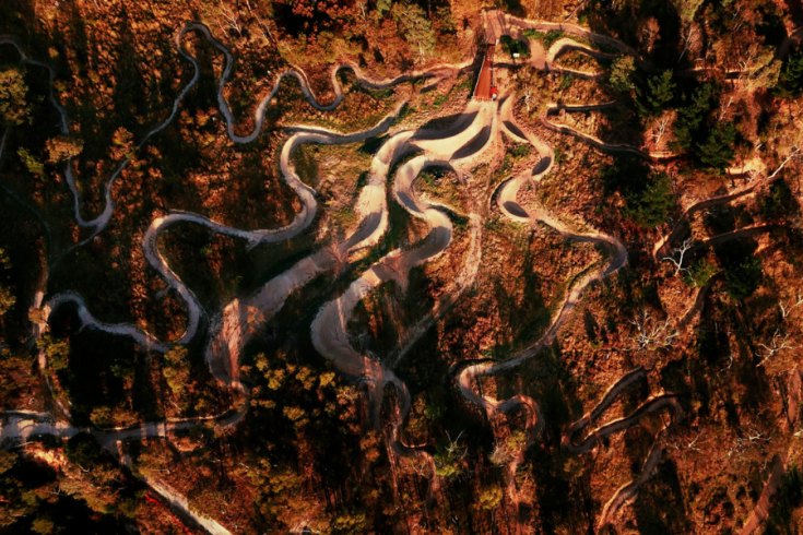 Drone image of the Omeo Mountain Bike Park showing weaving dirt tracks through dense bushland. 