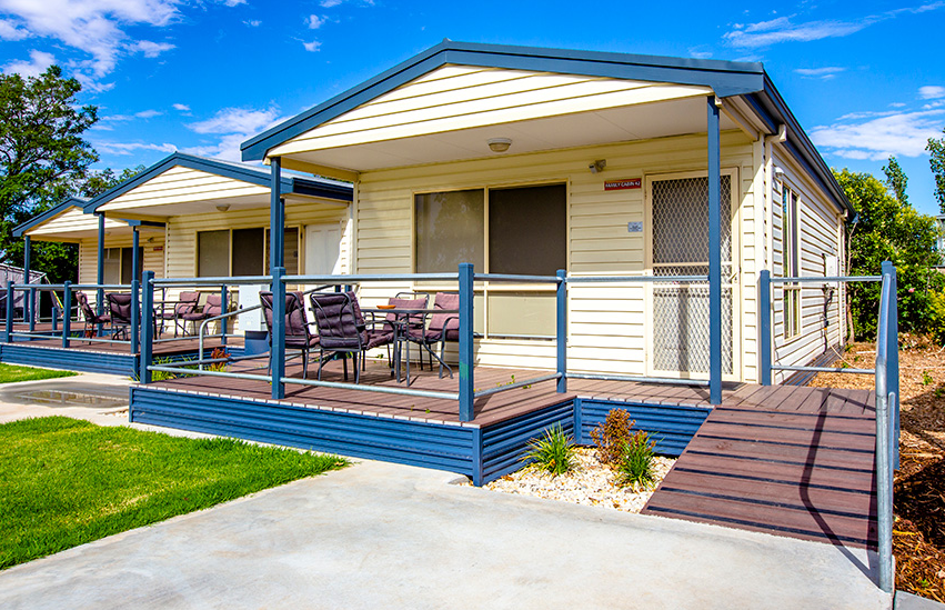 Two modern, single-story cabin units with wooden decks 