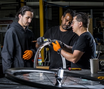 3 men using manufacturing products
