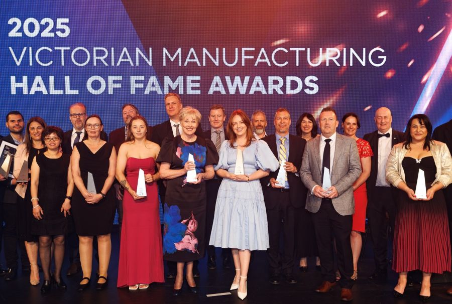 Group of people holding awards standing in front of sign 2025 Victorian Manufacturing Hall of Fame Awards