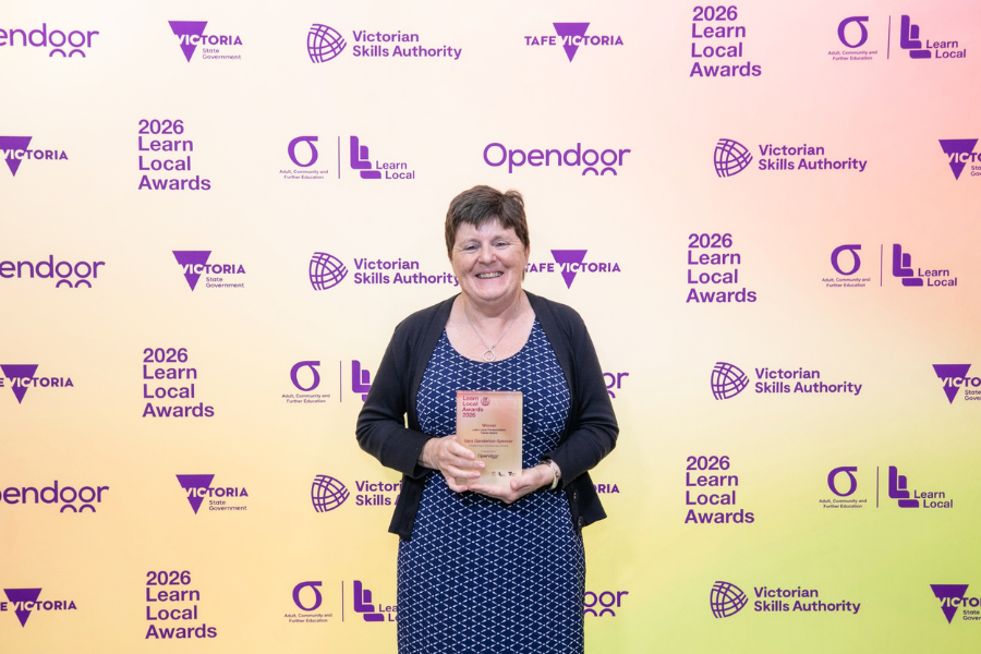 Sara Ganderton-Spencer standing with award