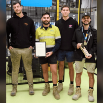 Luca Mascaro, Lucas Heritage and 2 other individuals posing with trade papers