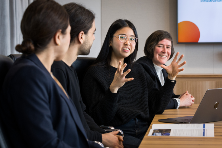 Corporate setting with people at meeting. 