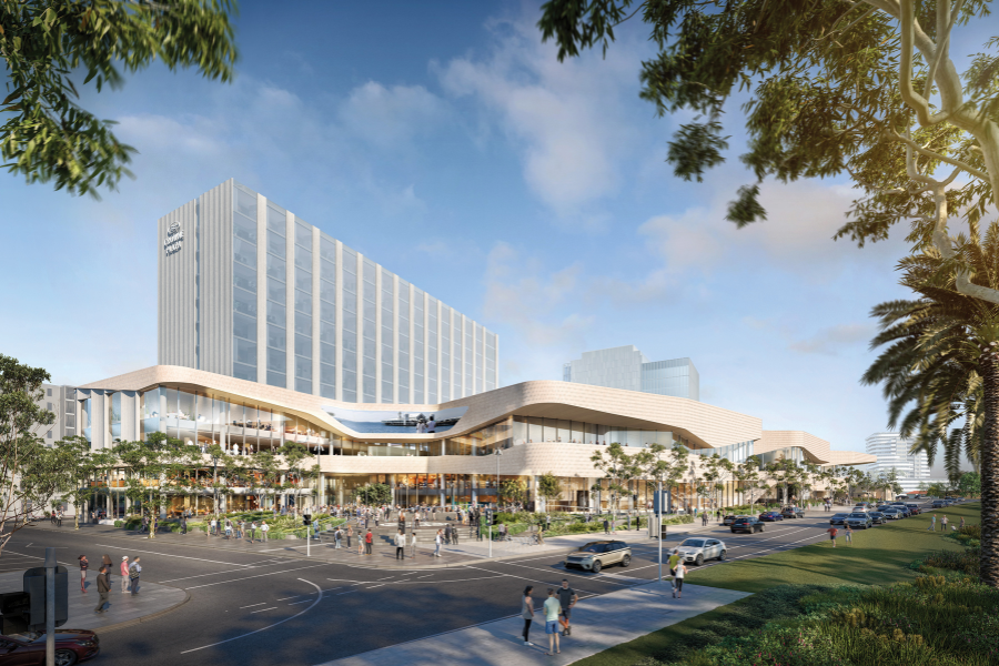 Architectural rendering of Geelong's Nyaal Banyul Convention and Exhibition Centre featuring a high-rise building and a curved, low-rise structure with extensive glazing, surrounded by landscaped greenery and a busy street scene.