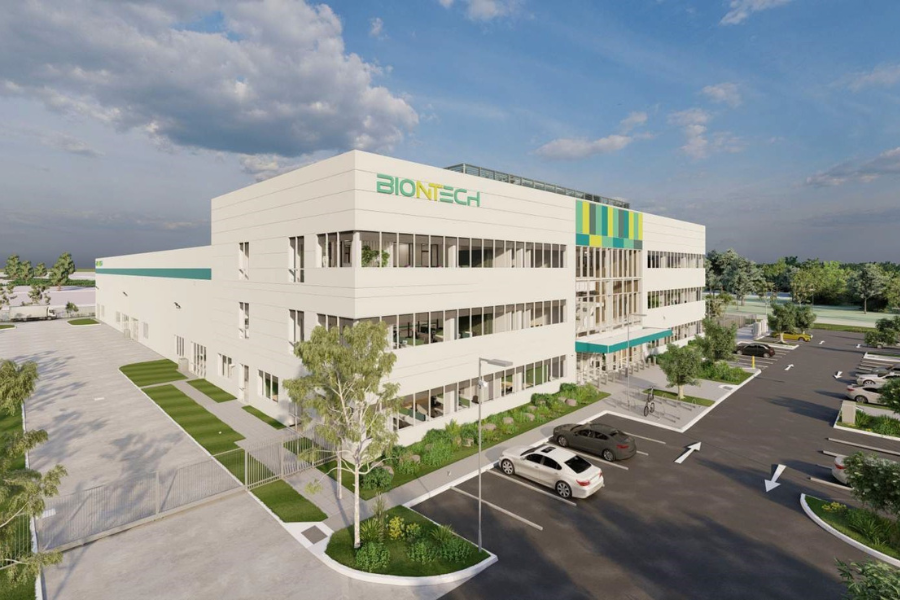 Digital rendering of a modern BioNTech building with expansive parking, surrounded by landscaped areas under a clear sky.