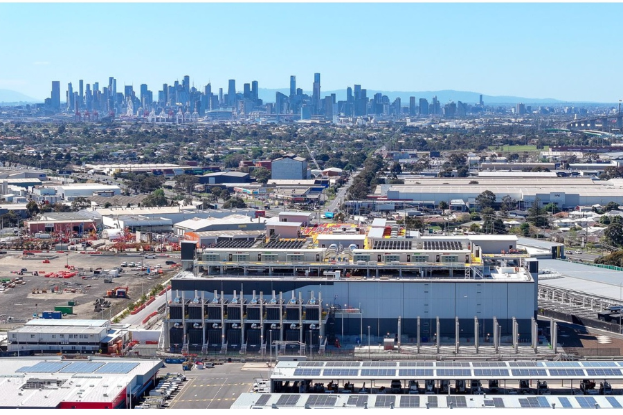 Aerial view of a data centre with industrial area around it. Melbourne skyline is in the background