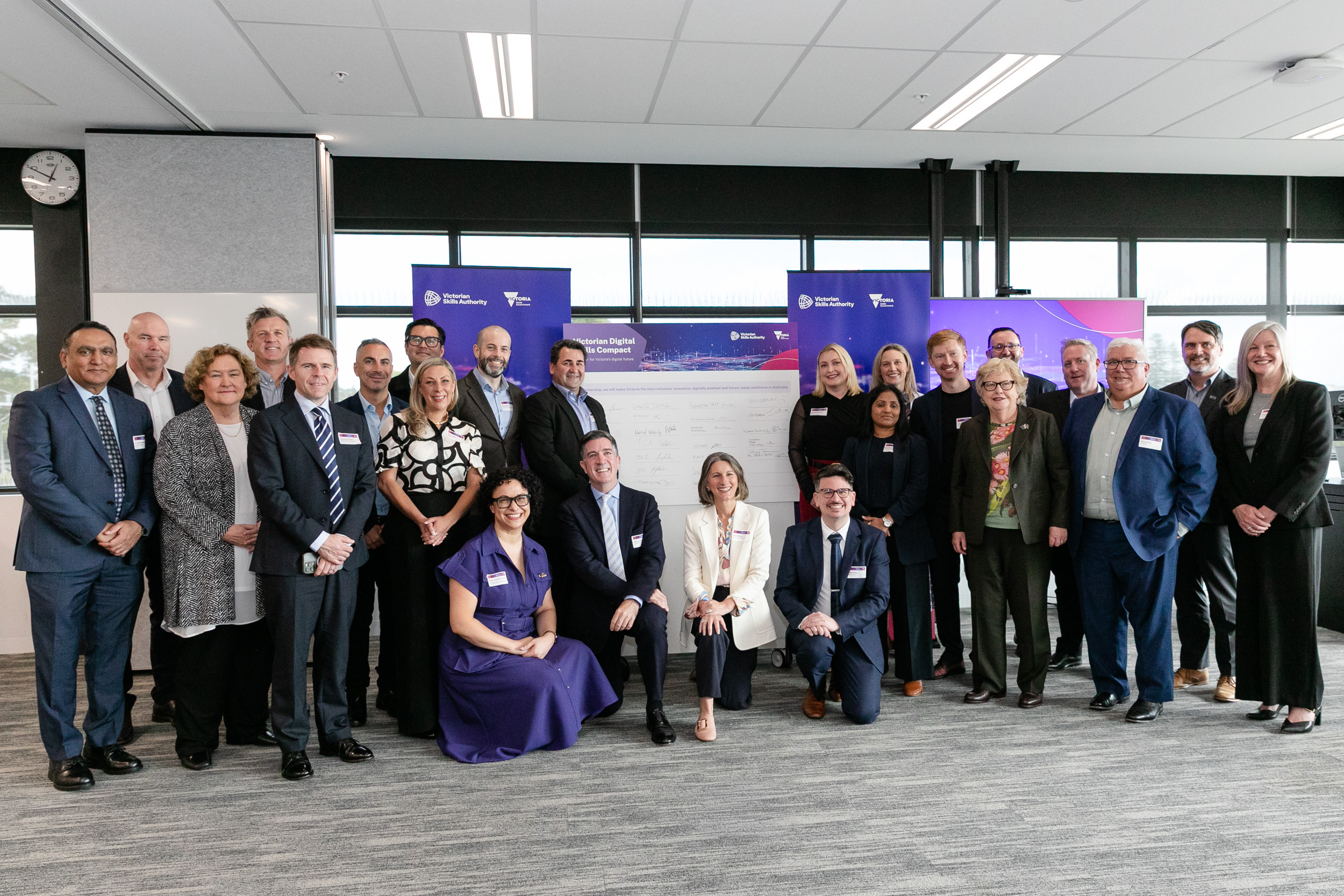 Various TAFE entities in the room signing the Victorian Digital Skills Compact. 