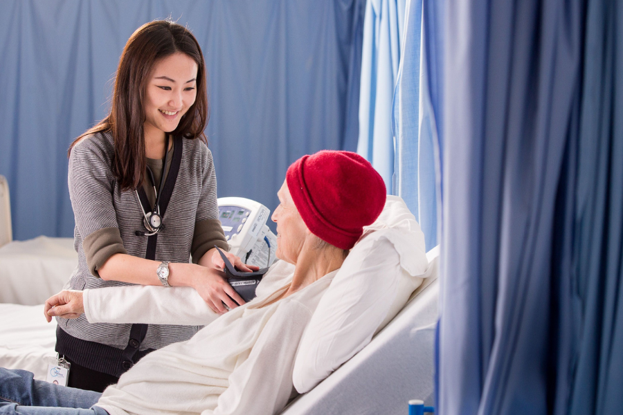 Medical professional tending to patient in a hospital setting. 