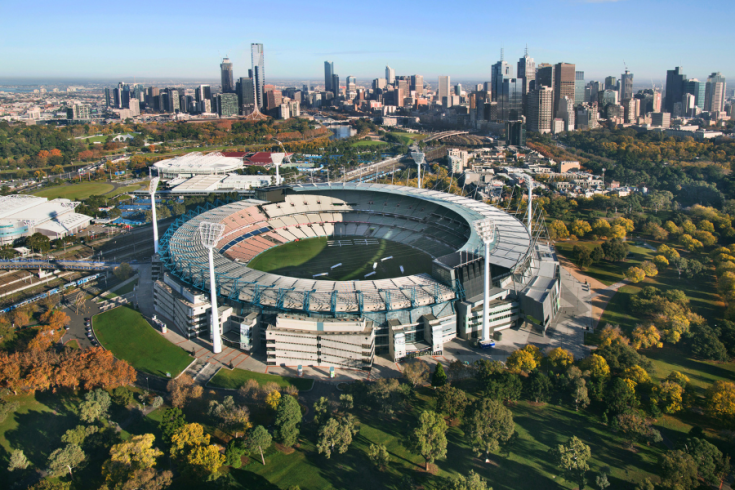 Birds-eye view of the Melbourne Cricket Ground with the Melbourne CBD in background.
