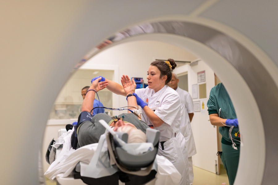 A healthcare worker in assisting patient with the examination process.