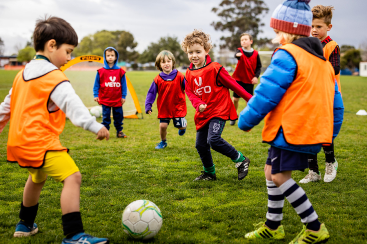 Group of children playing soccer