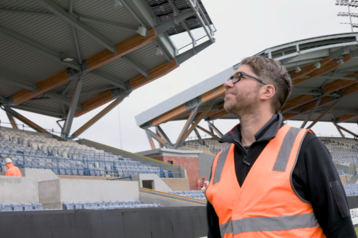 Person in hi-vis looking up at the expansive Mars Stadium roof