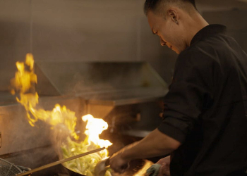 A chef cooking on a wok