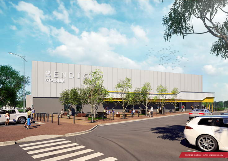 Artist impression of the Bendigo Stadium, showcasing a modern building with a prominent sign, surrounded by trees and a parking lot with cars and pedestrians.