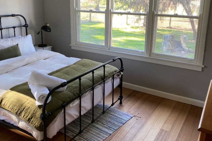 Modern queen bed with a rural country view out the window.
