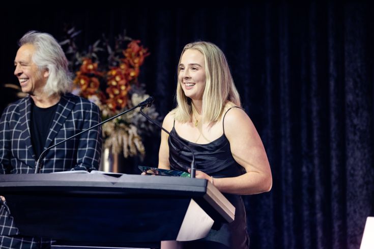 Rebecca Gibson, Trainee of the Year winner 2025 receiving award at podium