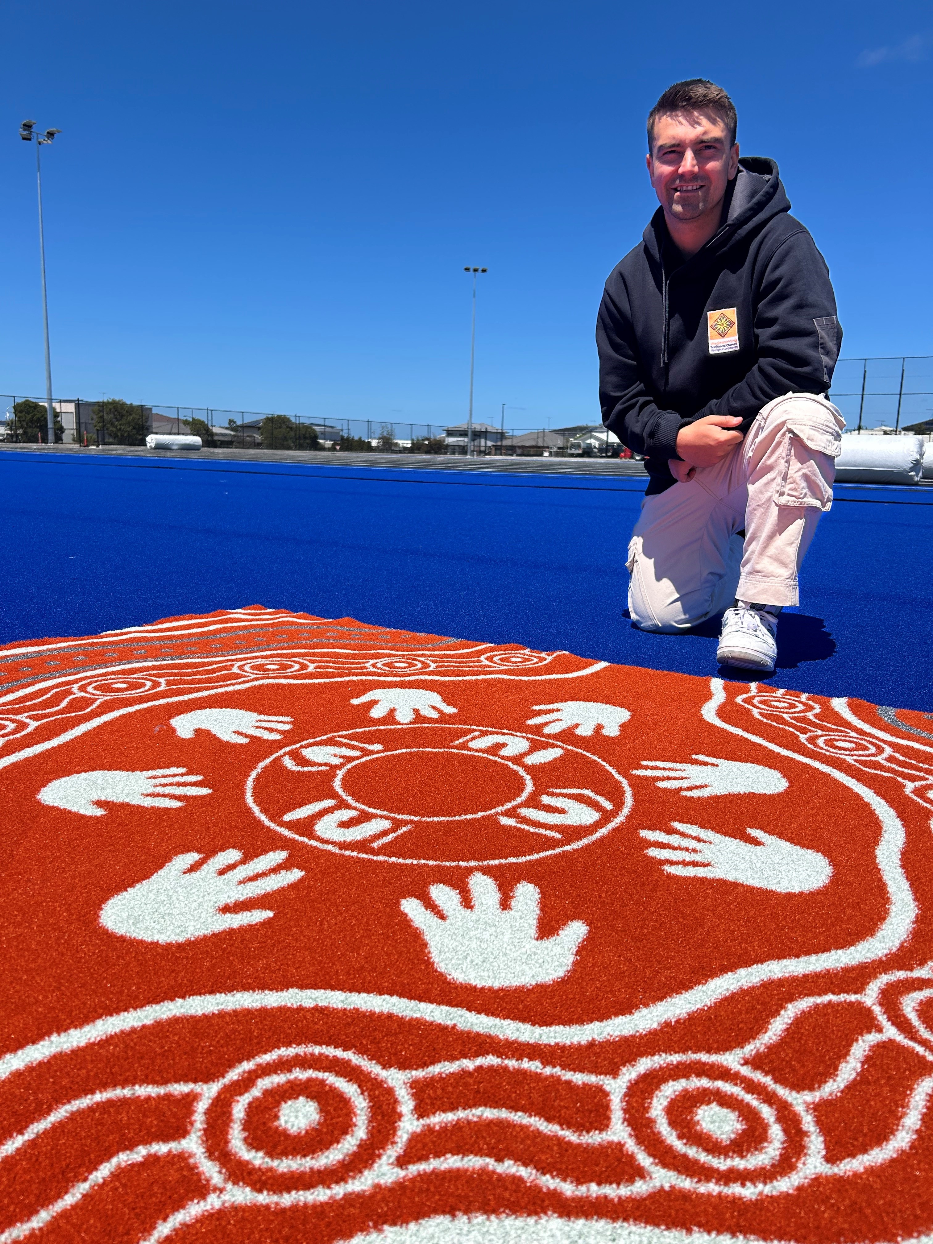 First Nations artist Billy-Jay O'Toole with his artwork, stitched into Banyul-Warri Fields First Nations artist Billy-Jay O'Toole with his artwork, to be stitched into Banyul-Warri Fields.jpg